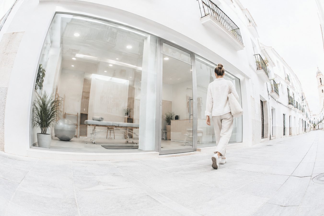 Glass-fronted facade of a physical therapy clinic on a white street